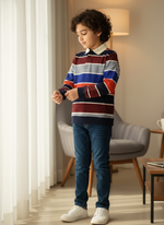 Child wearing a colorful striped sweater and blue jeans in a living room setting.