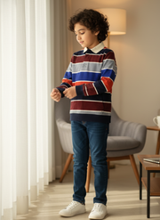 Child wearing a colorful striped sweater and blue jeans in a living room setting.
