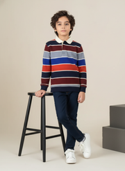 Child wearing a striped sweater and standing next to a stool on a plain background