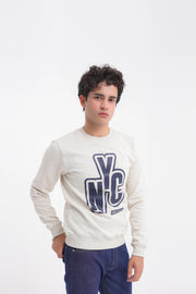 Person wearing a white sweatshirt with a blue 'NYC' logo on a white background