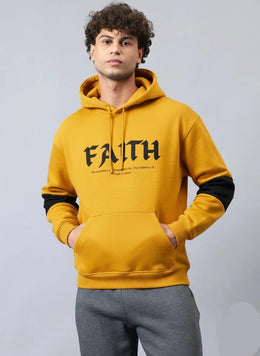 A man wearing mustard faith hoodie
